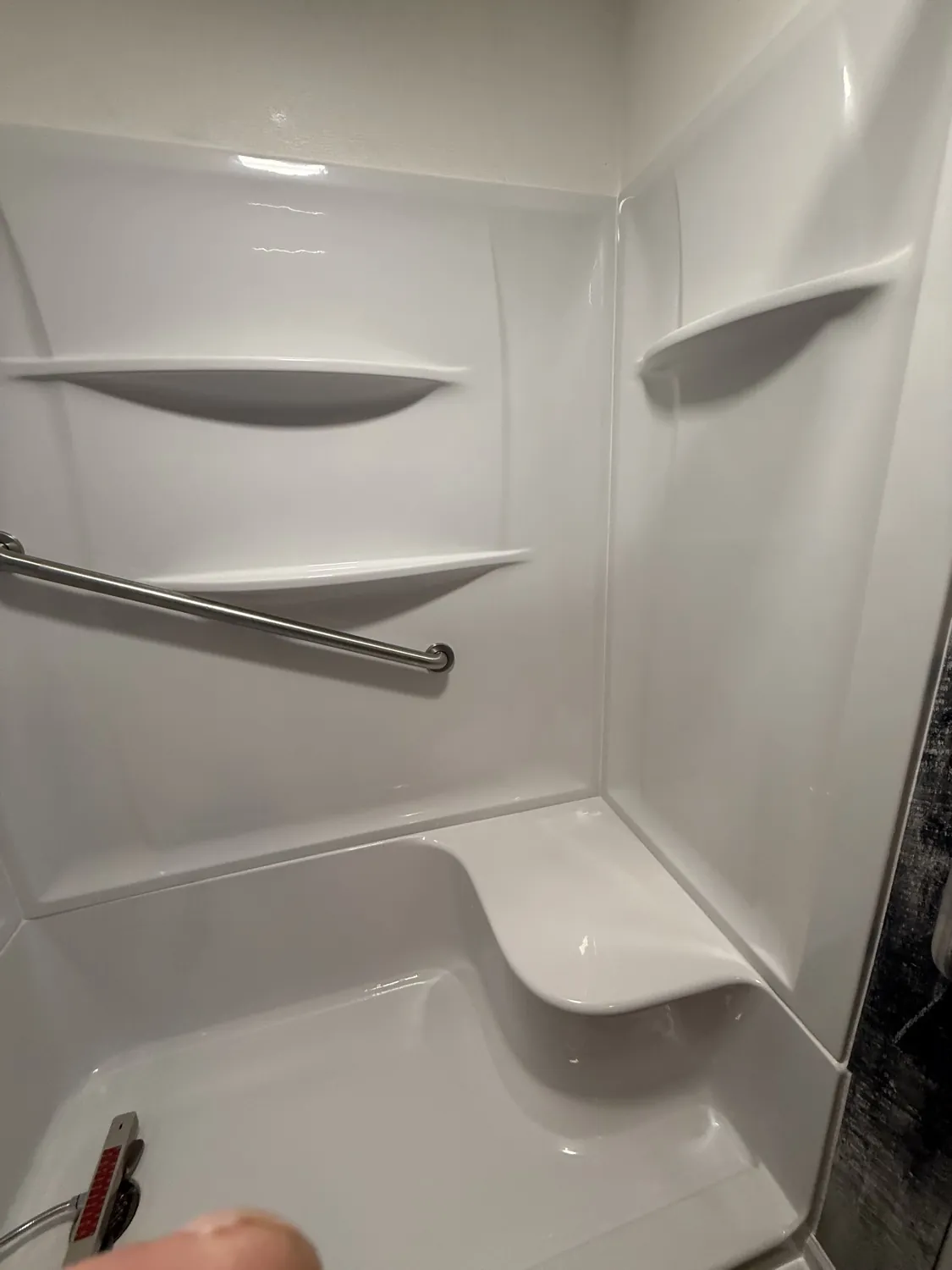 Accessible shower with built-in seat and grab bar