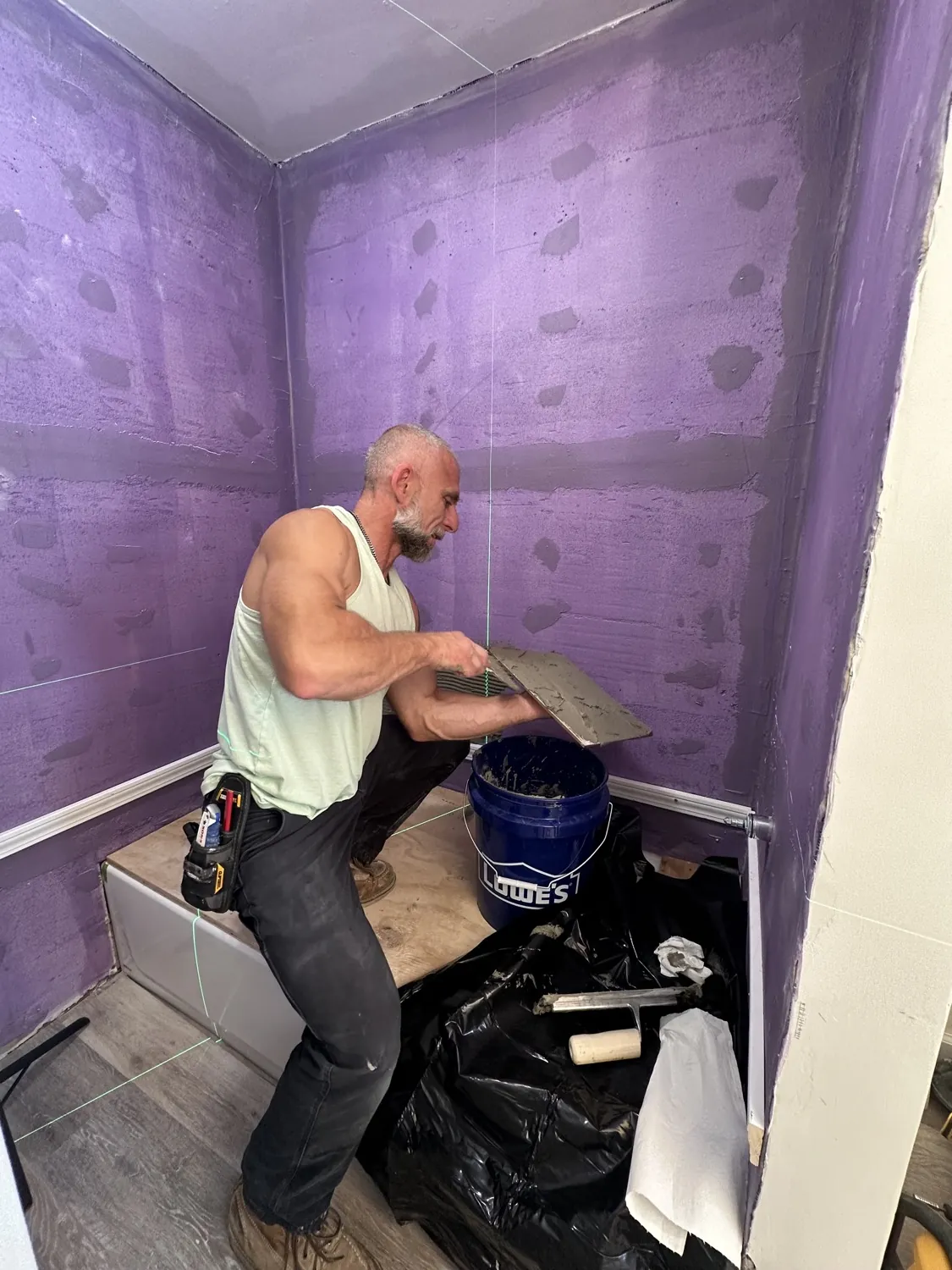 Say When Contracting craftsman applying waterproofing membrane to a shower before tiling
