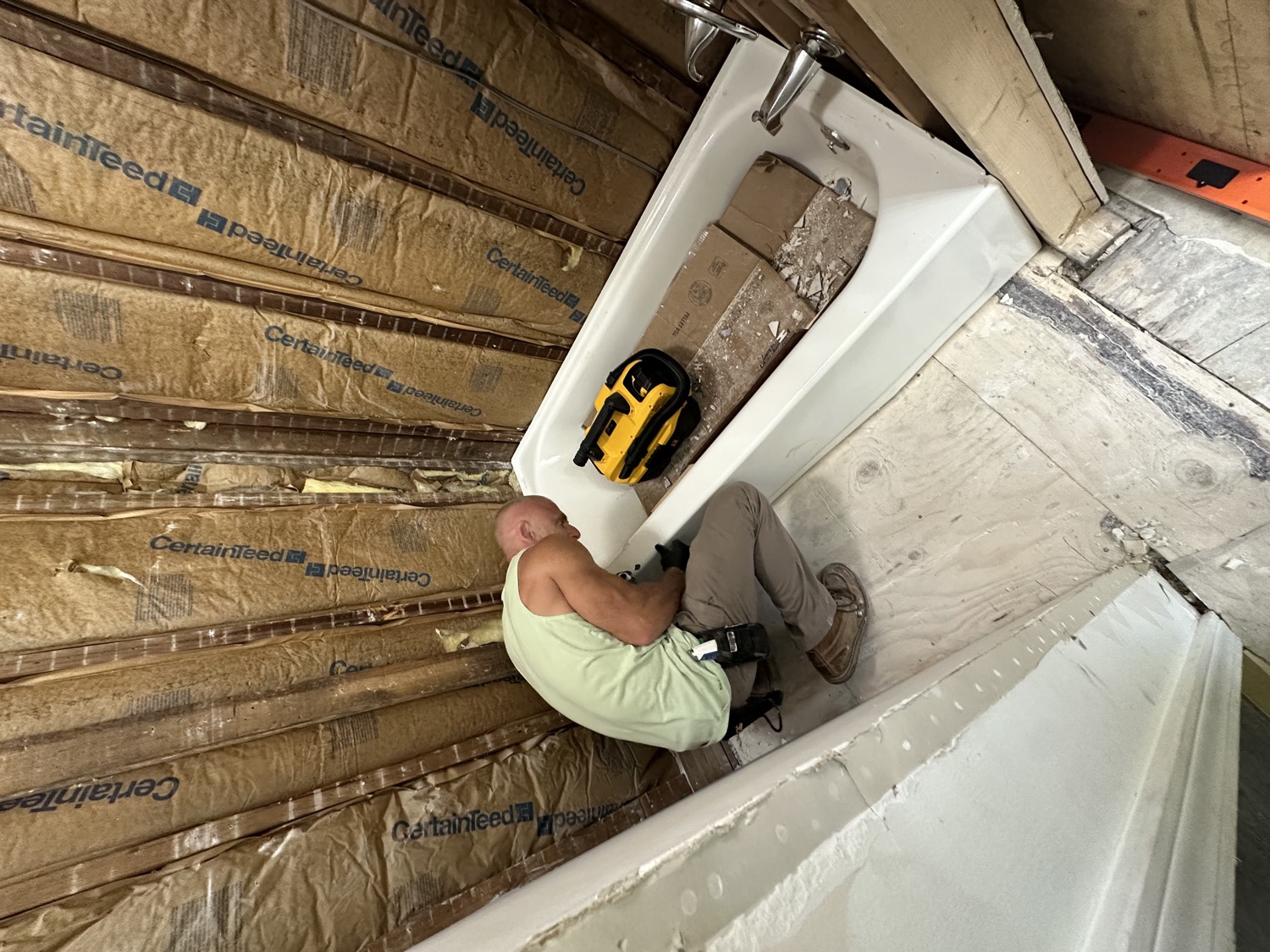 Eric, owner of Say When Contracting, installing a new tub on a job site