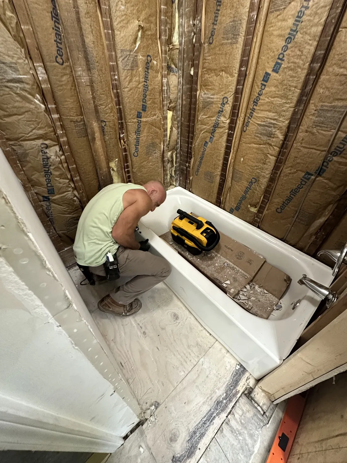 Eric, owner of Say When Contracting, installing a new tub on a job site