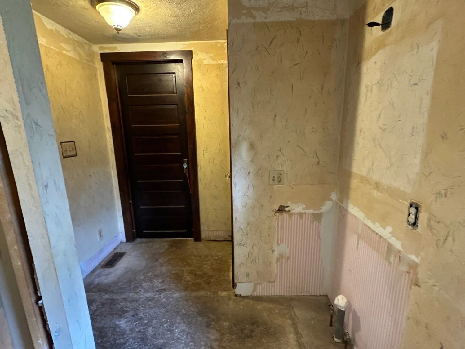 Century-home bathroom in New Hampshire, Ohio gutted to bare walls and subfloor before rebuilding