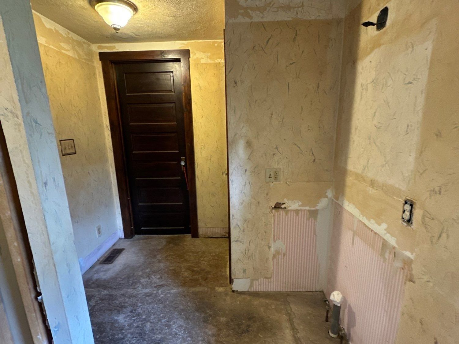 Century-home bathroom in New Hampshire, Ohio gutted to bare walls and subfloor before rebuilding